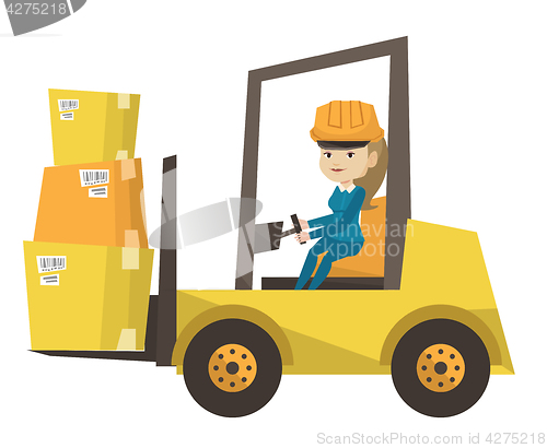 Image of Warehouse worker moving load by forklift truck.