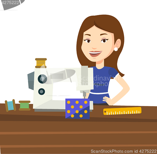 Image of Seamstress using sewing machine at workshop.