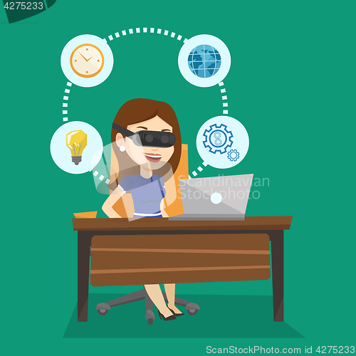 Image of Business woman in vr headset working on computer.