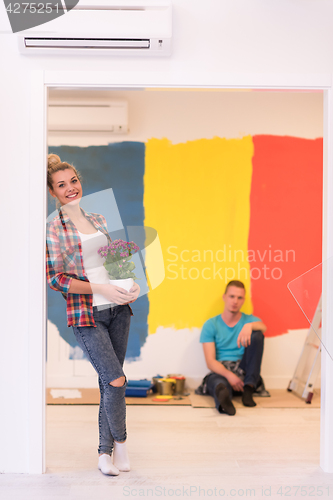 Image of happy young couple doing home renovations