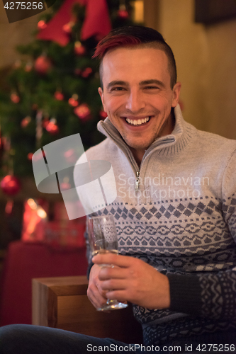 Image of Happy young man with a glass of champagne