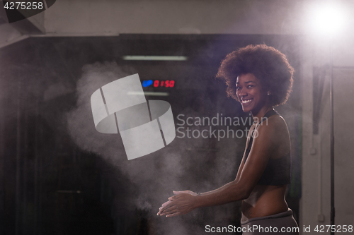 Image of black woman preparing for climbing workout