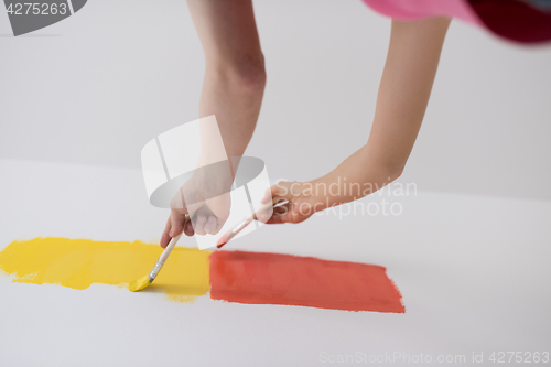 Image of couple painting interior wall