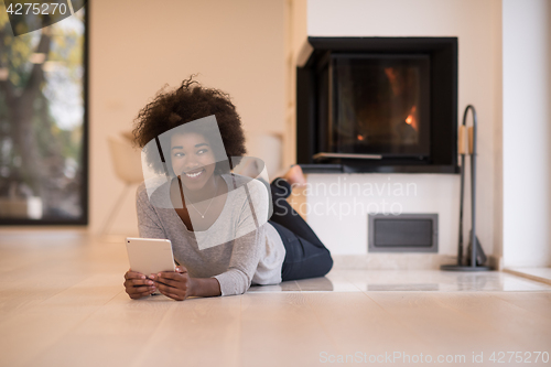 Image of black women using tablet computer on the floor