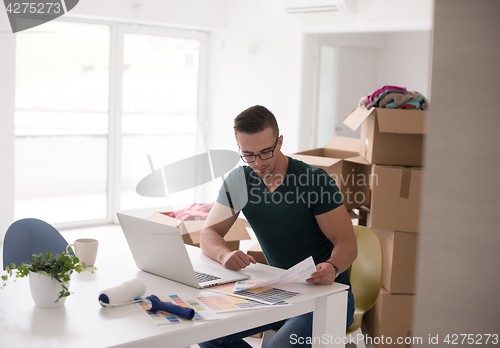 Image of Young man moving in a new home