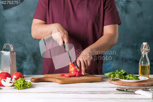 Image of Closeup hand of chef baker making pizza at kitchen