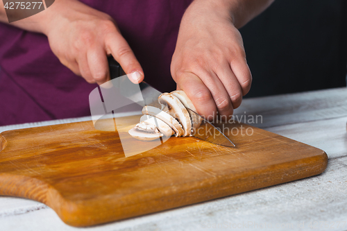 Image of Closeup hand of chef baker making pizza at kitchen