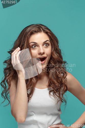 Image of Portrait of young woman with shocked facial expression