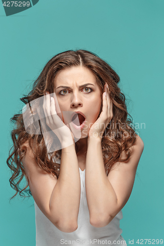 Image of Portrait of young woman with shocked facial expression