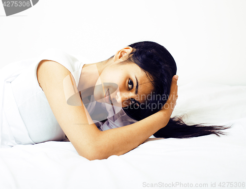 Image of young pretty tann woman in bed among white sheets having fun, tr