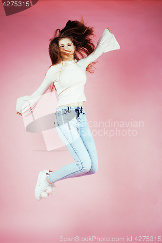 Image of young pretty teenage redhair girl jumping cheerful isolated on pink background, lifestyle people concept 