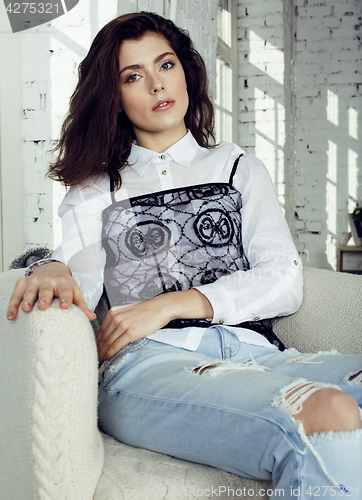 Image of young pretty woman in her bedroom sitting in chair, lifestyle people concept