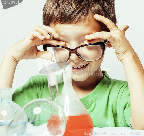 Image of little cute boy with medicine glass isolated wearing glasses smi