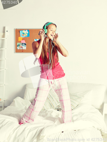 Image of happy woman in headphones ihaving fun at home