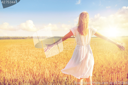 Image of happy young woman in white dress on cereal field