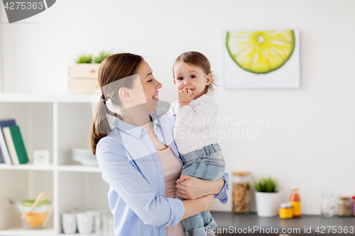 Image of happy mother and little baby girl at home kitchen