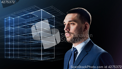 Image of businessman in suit with virtual building hologram
