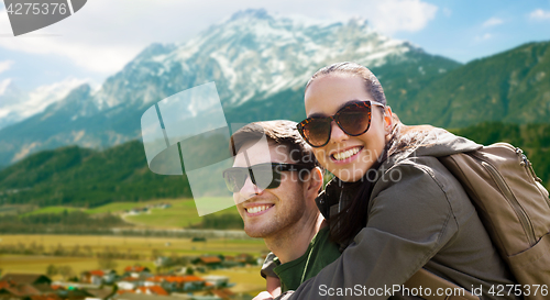 Image of happy couple with backpacks traveling in highlands