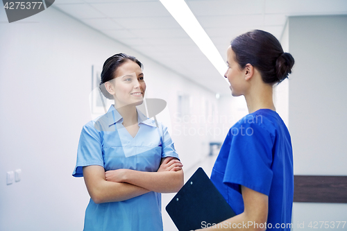 Image of medics, nurses or doctors talking at hospital