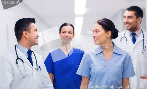 Image of happy group of medics or doctors at hospital