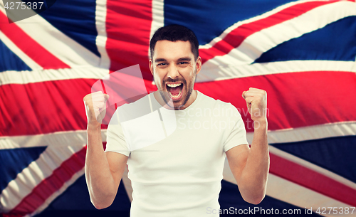 Image of angry man showing fists over brittish flag