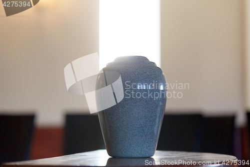 Image of cremation urn on table in church