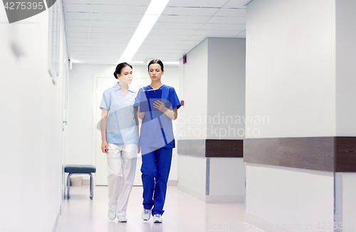 Image of two medics or nurses at hospital with clipboard