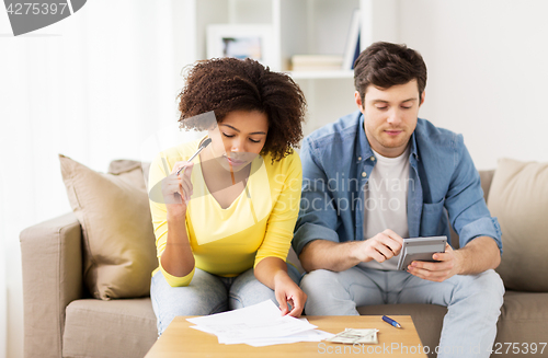 Image of couple with papers and calculator at home