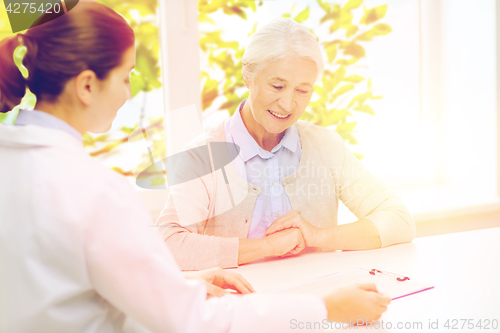 Image of doctor with clipboard and senior woman at hospital