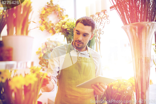 Image of man with tablet pc computer at flower shop