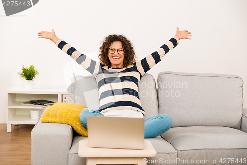 Image of Beautiful woman working at home