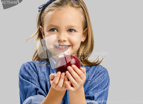 Image of Cute girl holding an apple