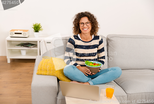 Image of Beautiful woman eating a salad