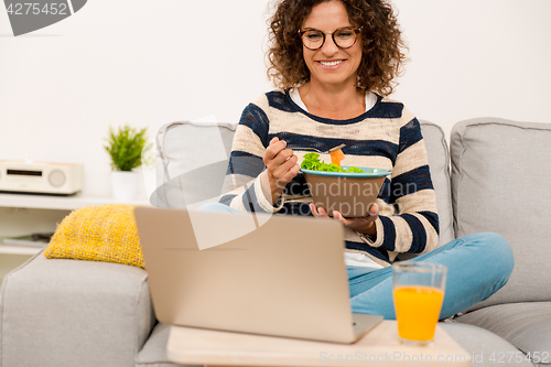 Image of Beautiful woman eating a salad