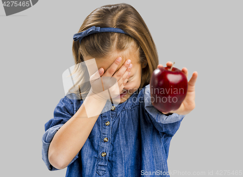 Image of Cute girl holding an apple