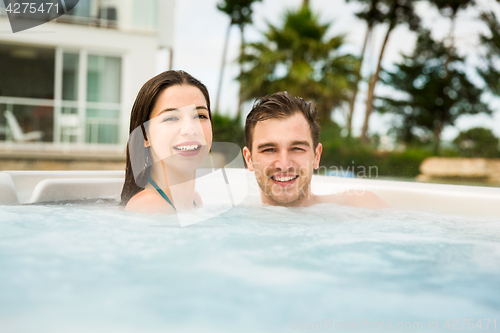 Image of Young couple in a jacuzzi