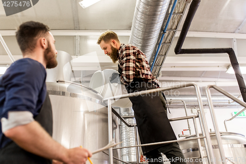 Image of men working at craft brewery or beer plant