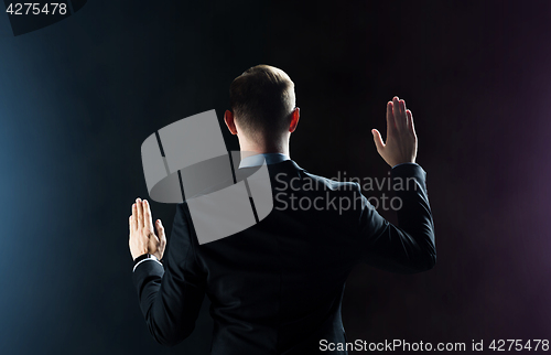 Image of businessman touching something invisible