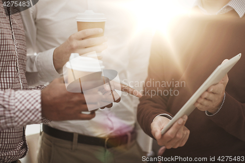 Image of business team with tablet pc and coffee at office