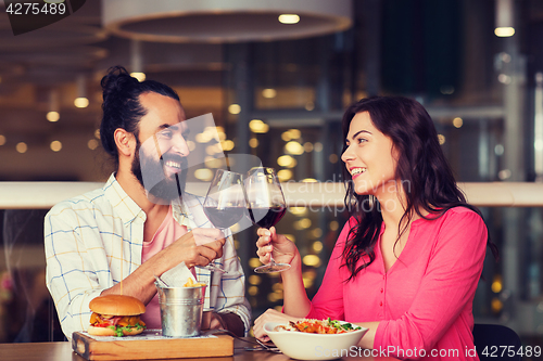 Image of happy couple dining and drink wine at restaurant