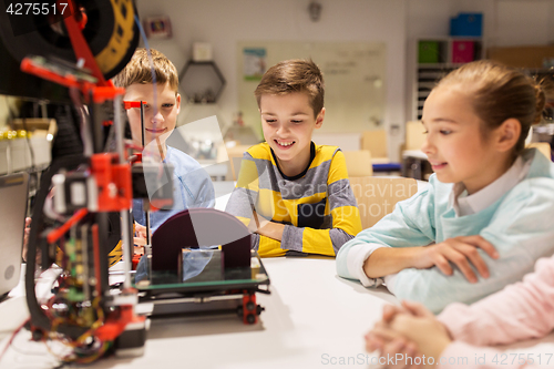 Image of happy children with 3d printer at robotics school