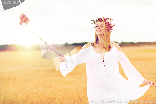 Image of happy young woman taking selfie by smartphone