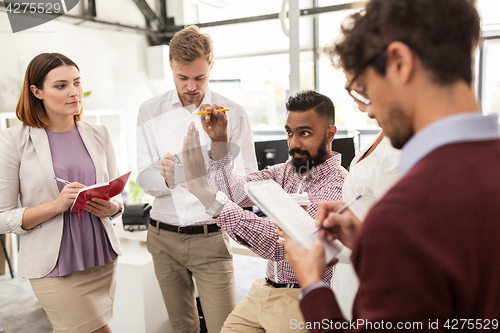 Image of happy business team discussing something at office