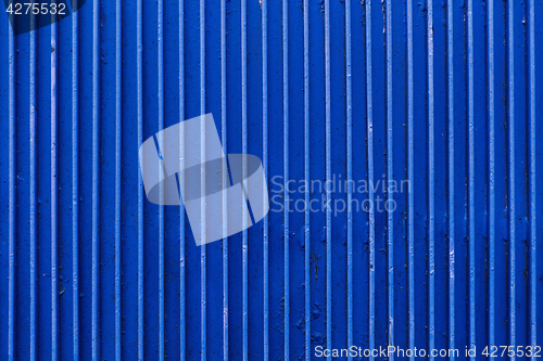 Image of old blue painted metal ribbed surface