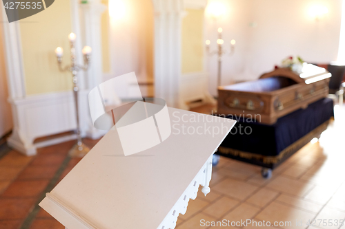 Image of stand or tribune and coffin in church