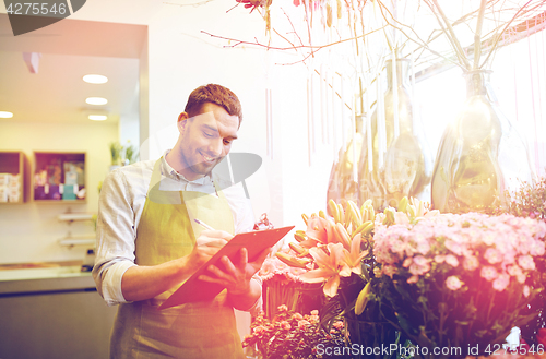 Image of florist man with clipboard at flower shop