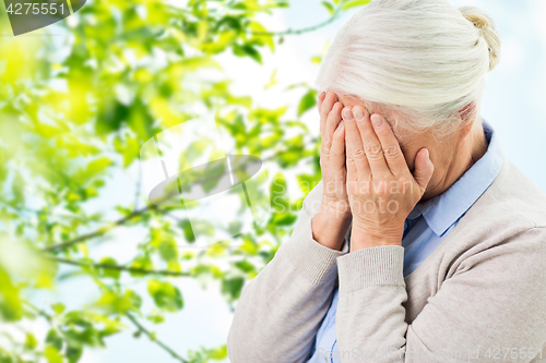 Image of senior woman suffering from headache or grief