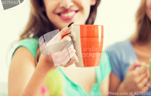 Image of happy woman or teen girl drinking tea from cup