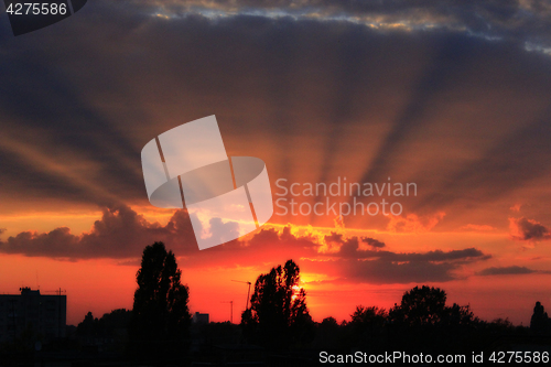 Image of summer sunset with dark sky and sun