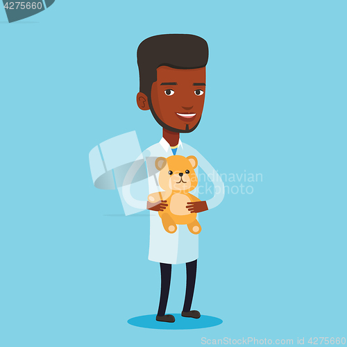 Image of Pediatrician doctor holding teddy bear.